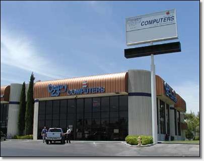 Picture of Meadows Lane building, large white glass fronted with copper soffet roof.